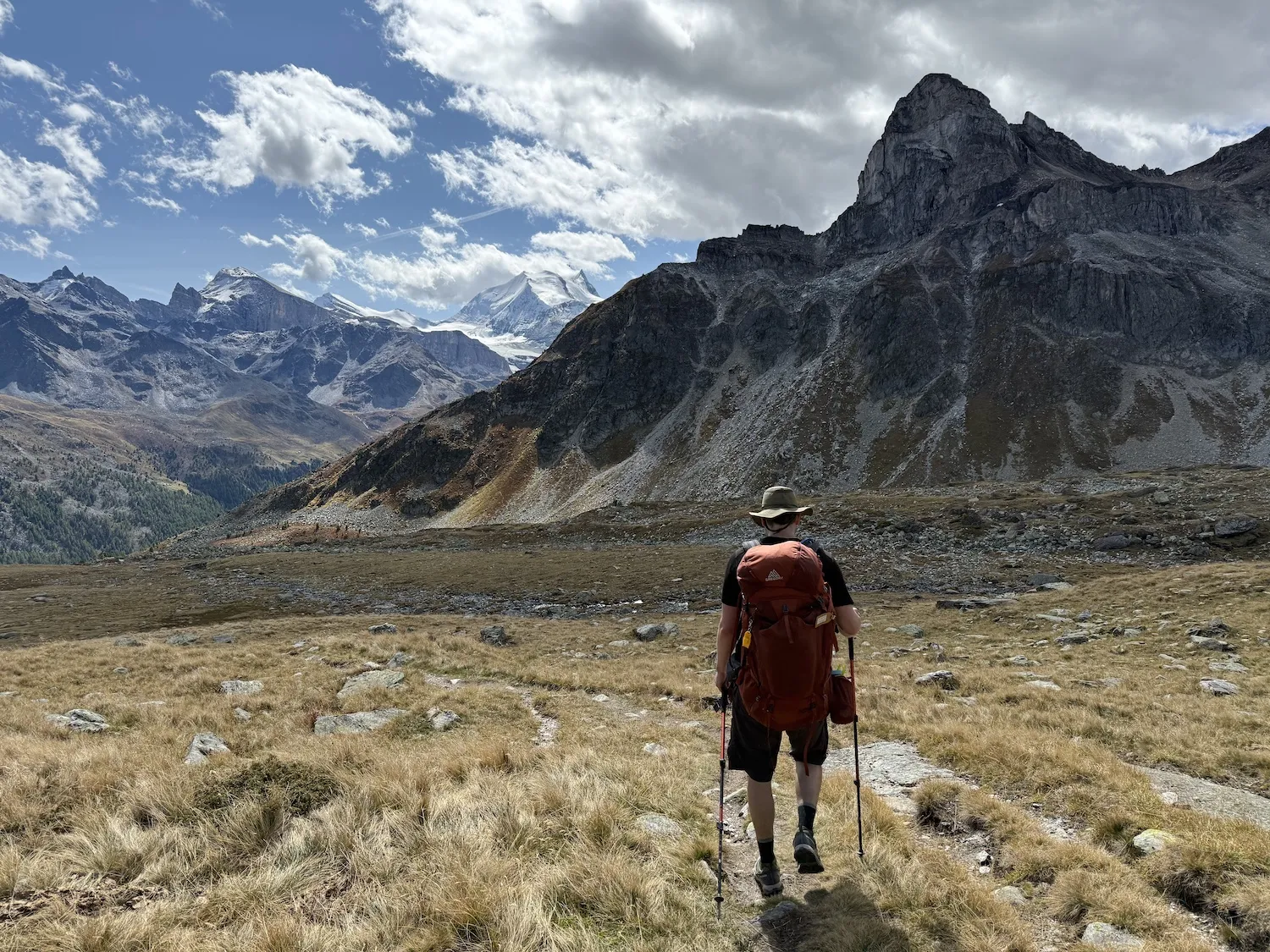 Man walking away towards mountains
