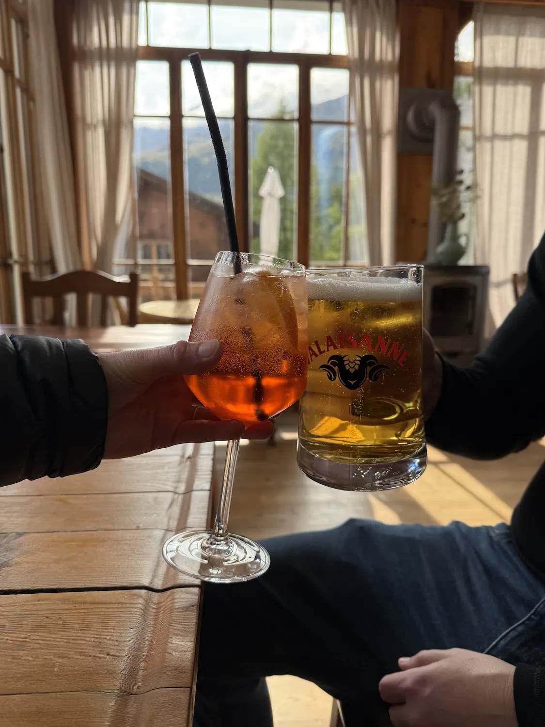 Aperol spritz and beer cheersing