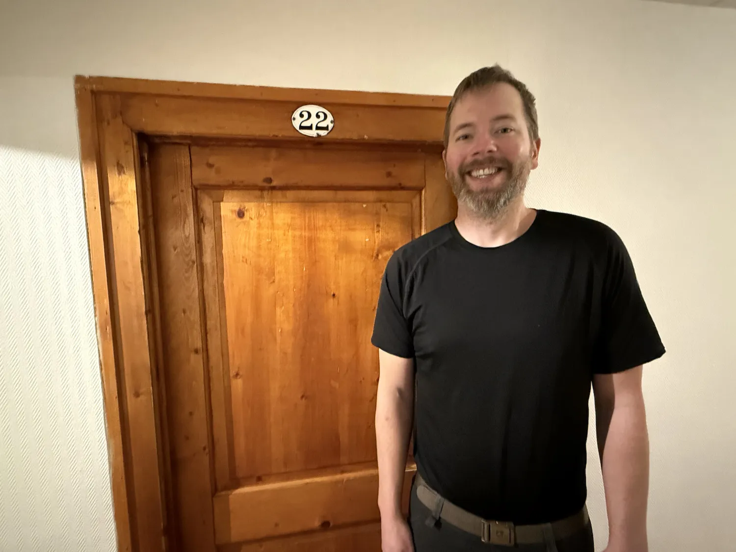 Man next to door that's shorter than him