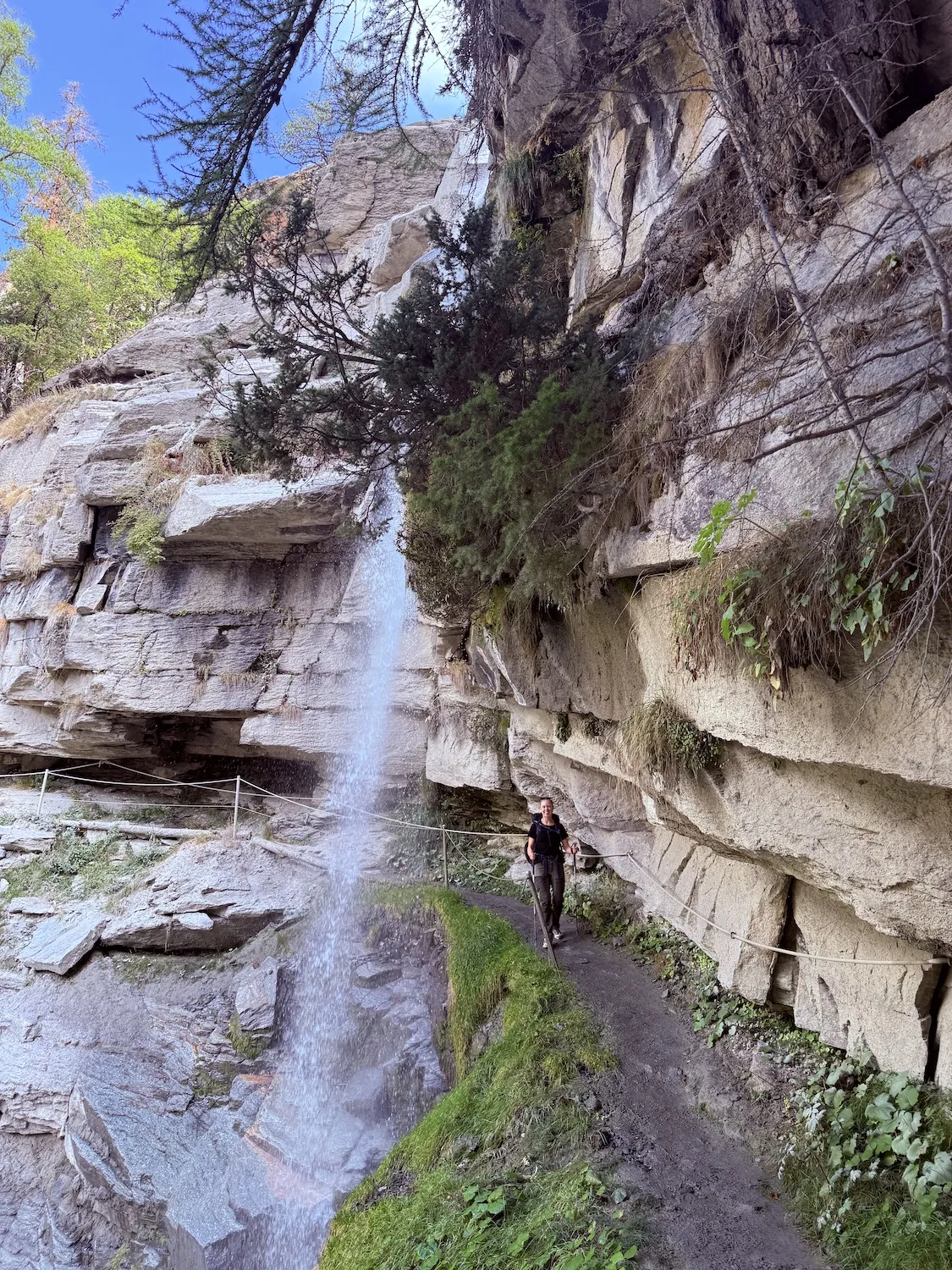 Woman walking under waterfall