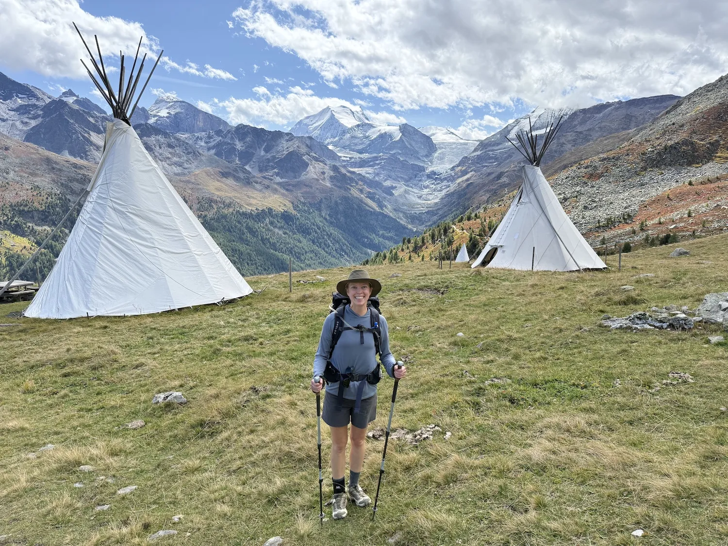 Woman in front of two teepees