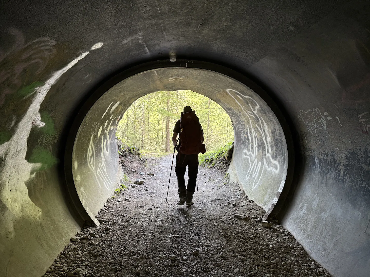 Man walking through tunnel