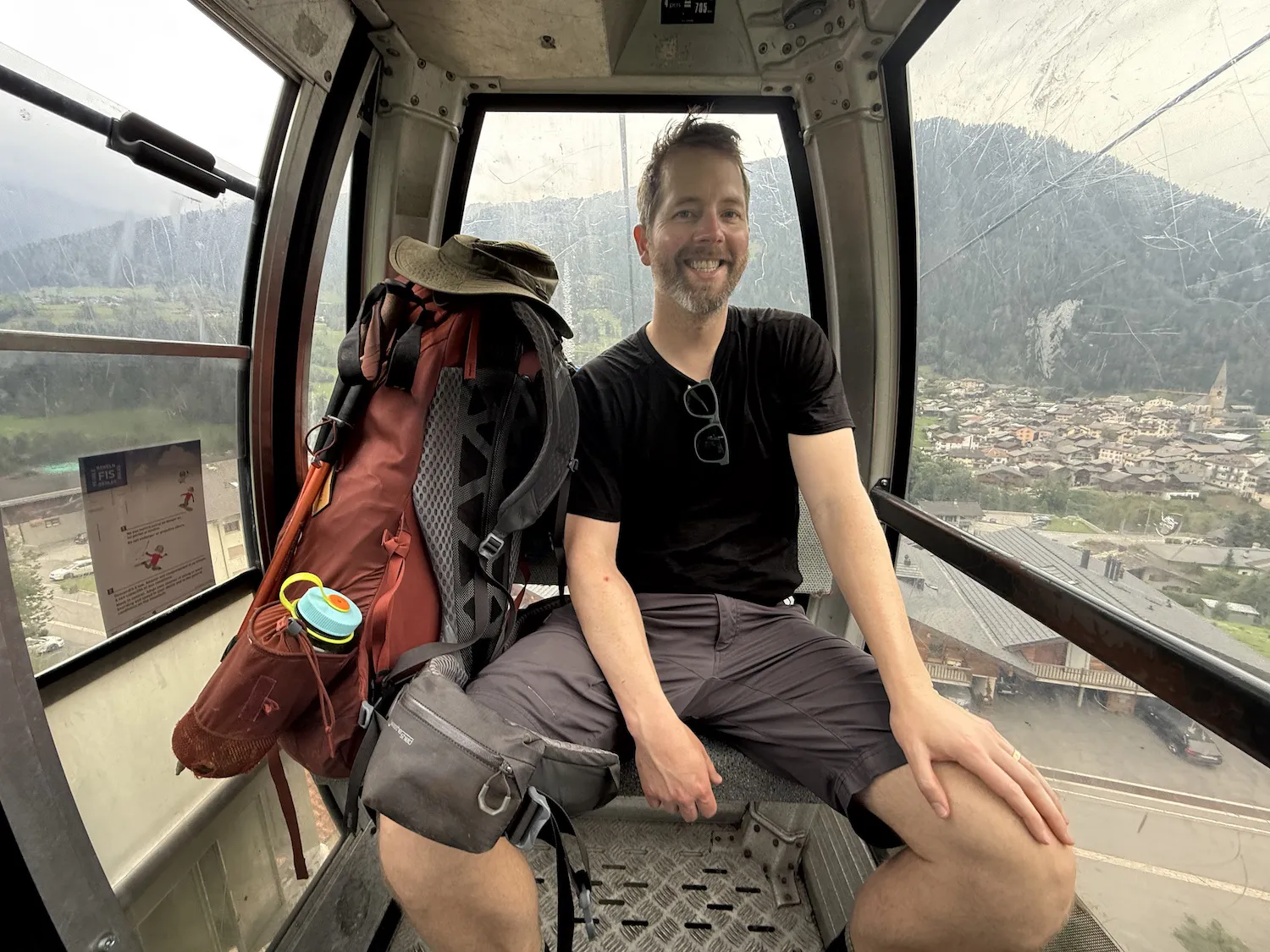 man on a gondola with big backpack