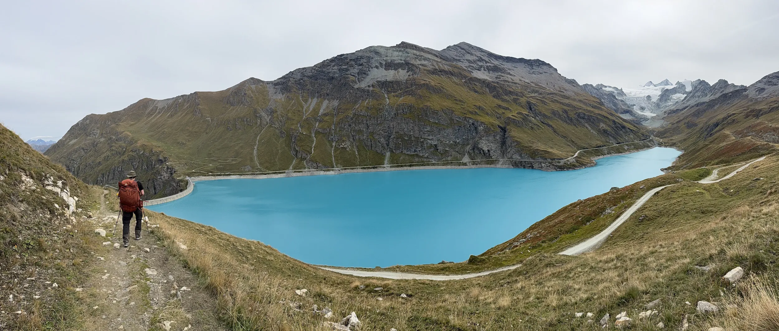 Panoramic view of man walking near blue lake