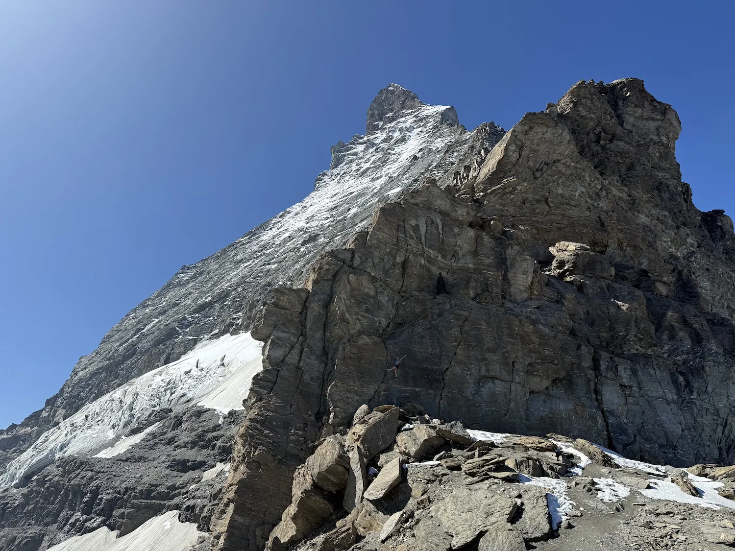 Woman hanging off of ladder on mountain
