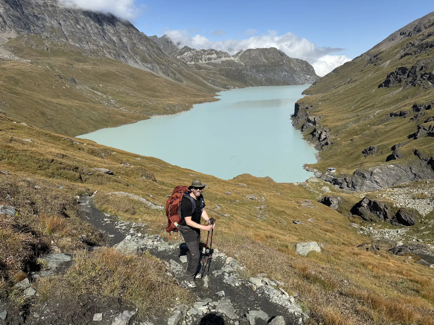Man in front of gray watered lake