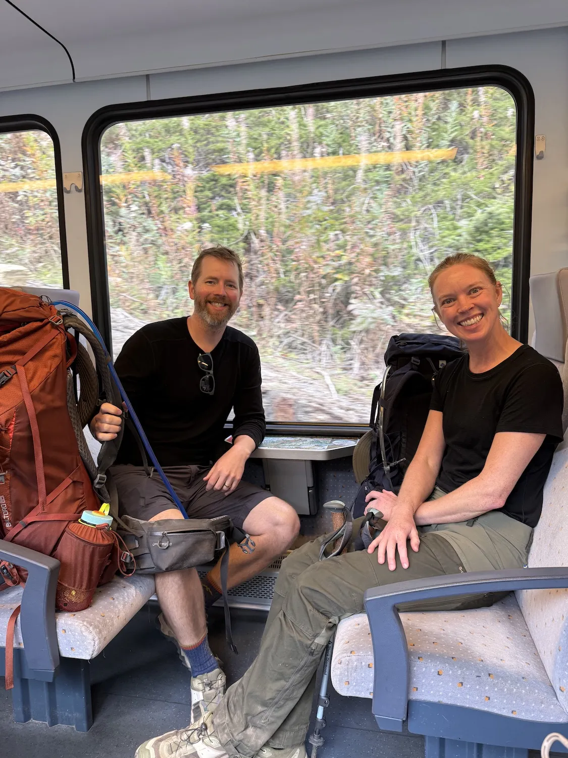 Couple on train with big backpacks
