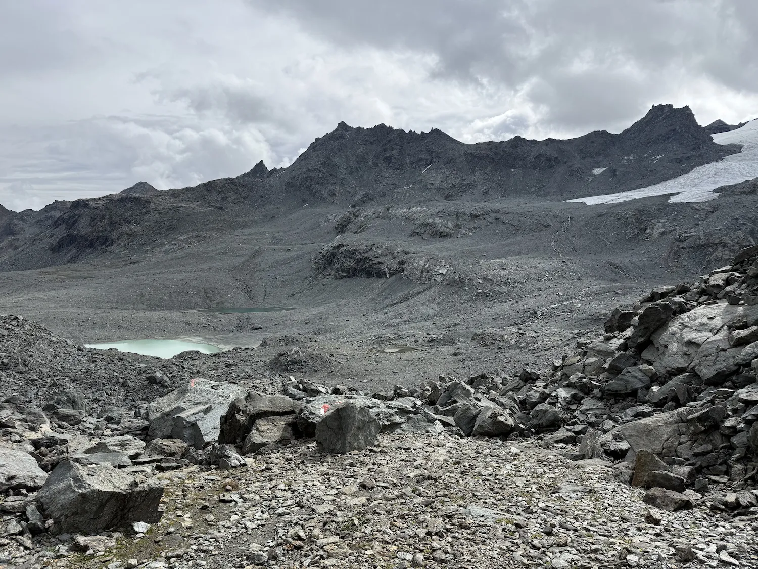 Desolate boulder field with lake