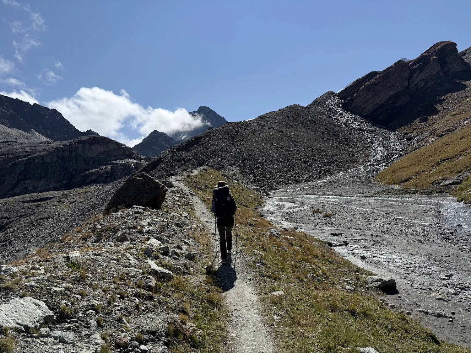 Woman walking on rocky mountainous trail