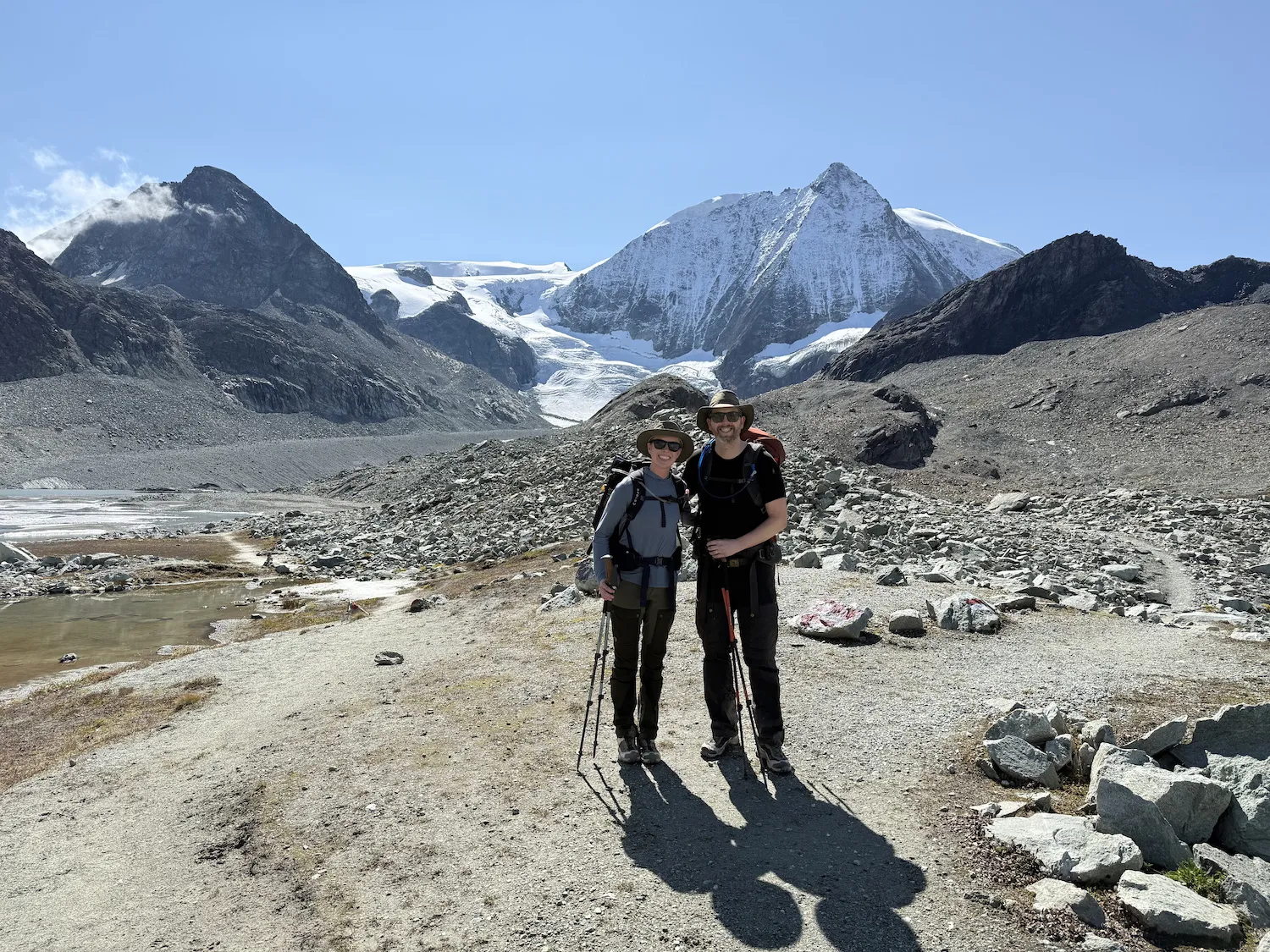 Man and woman in front of snowy mountain