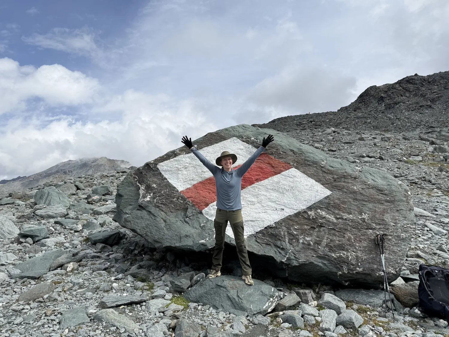 Woman in front of giant boulder with painted marker