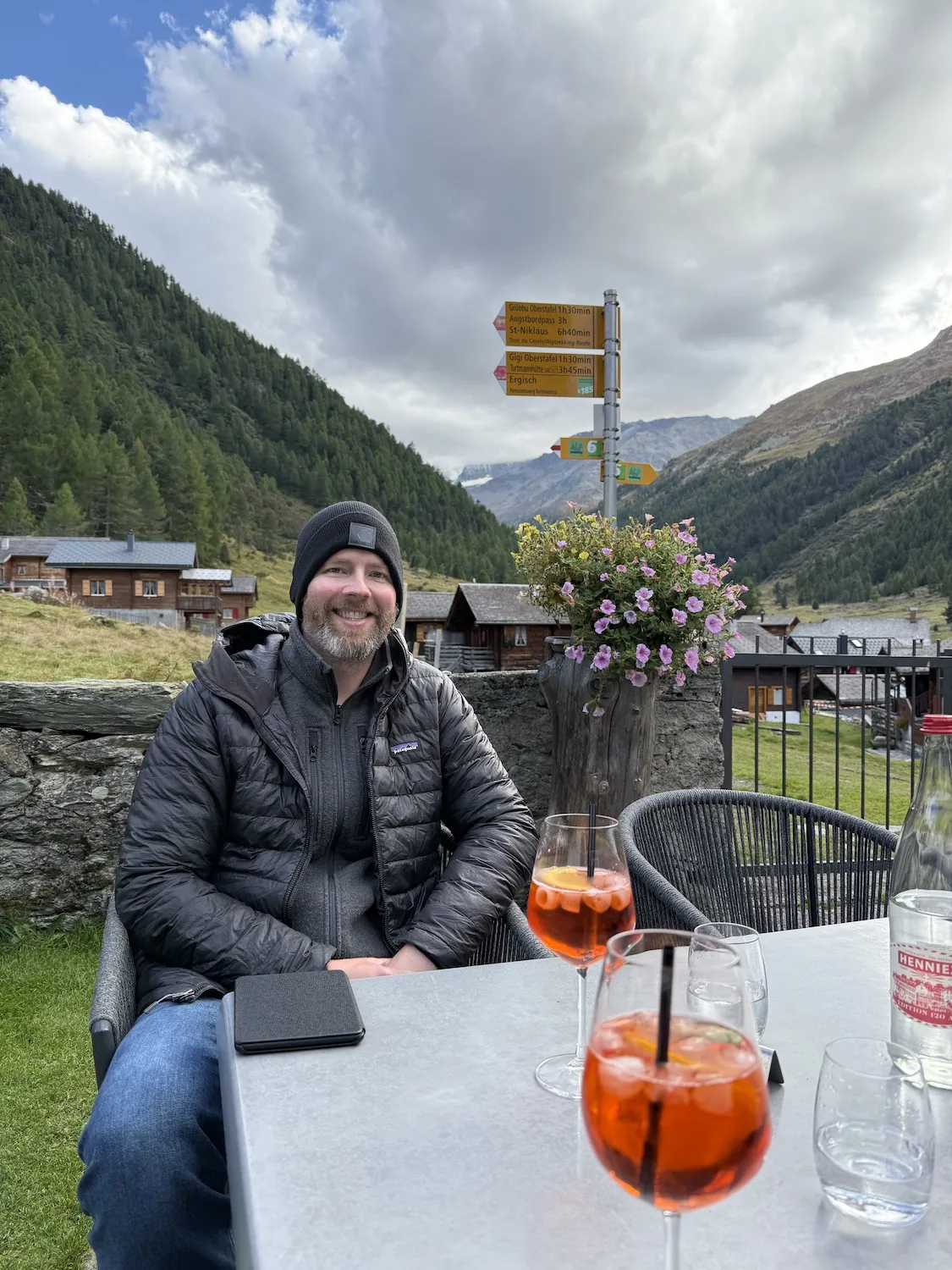 Man wearing a beanie in front of two drinks