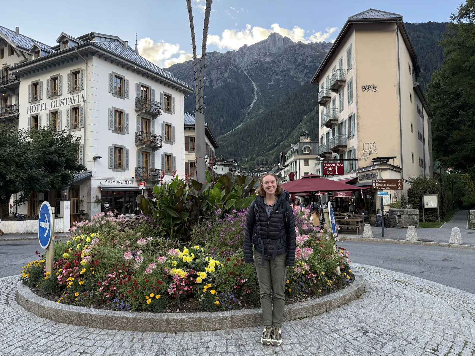 Sheryl standing in a traffic circle with flowers