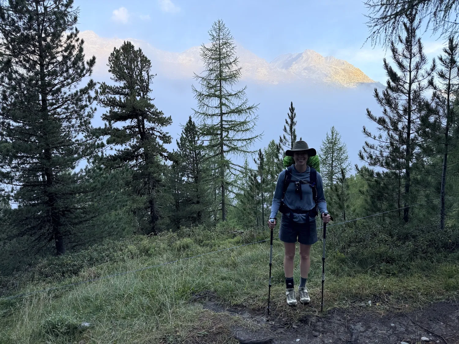 Woman standing in cloudy mountains