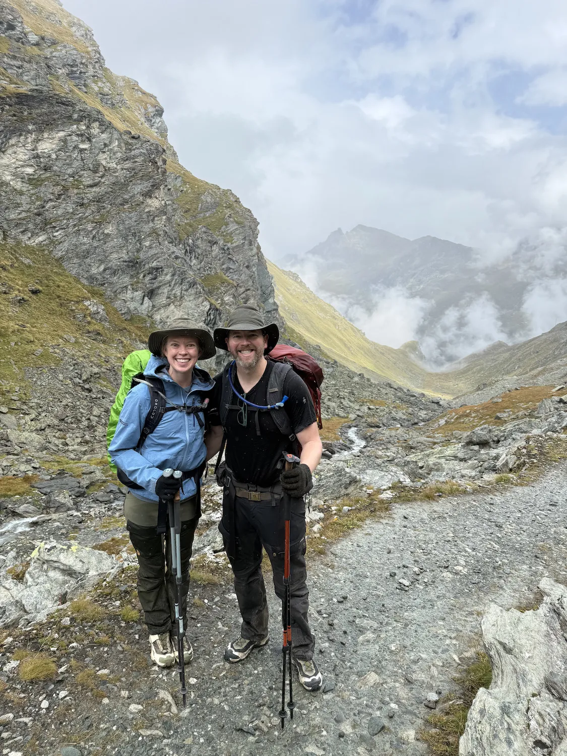 Man and woman in front of river in the distance