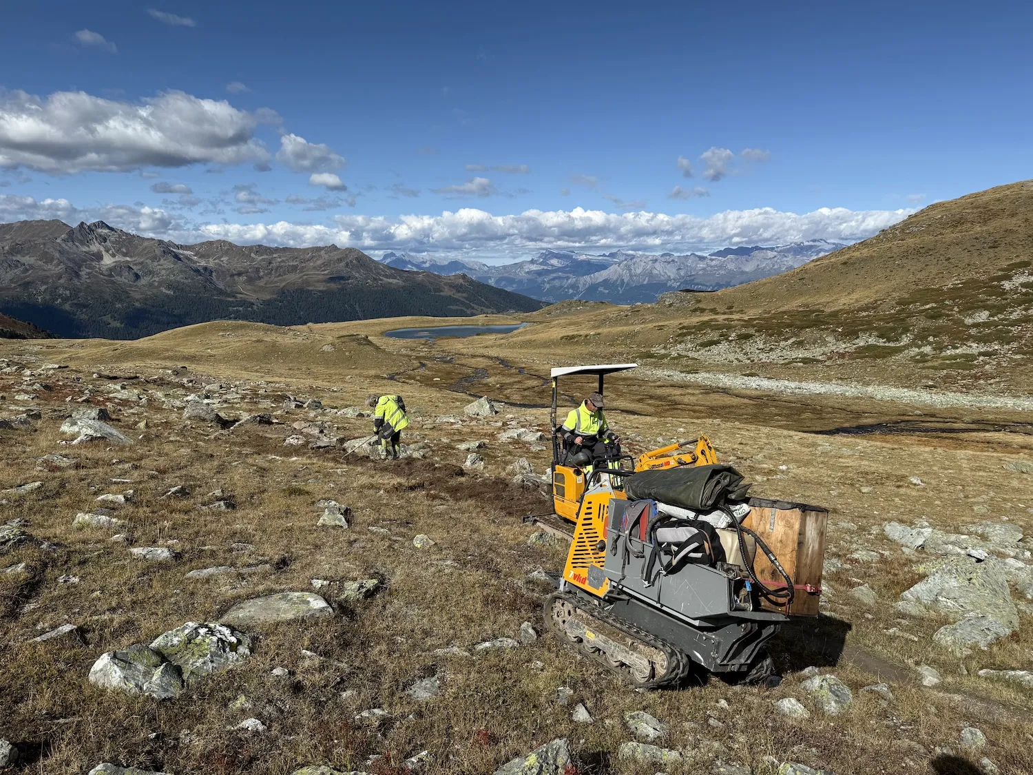 Two men doing construction on mountain