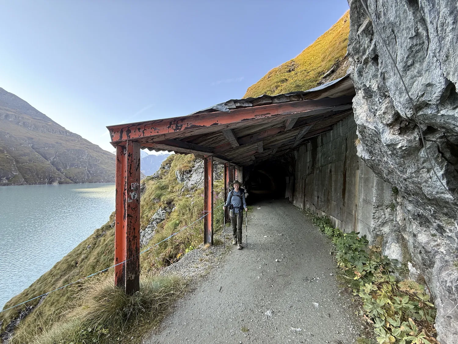 Woman standing in front of lake and tunnel