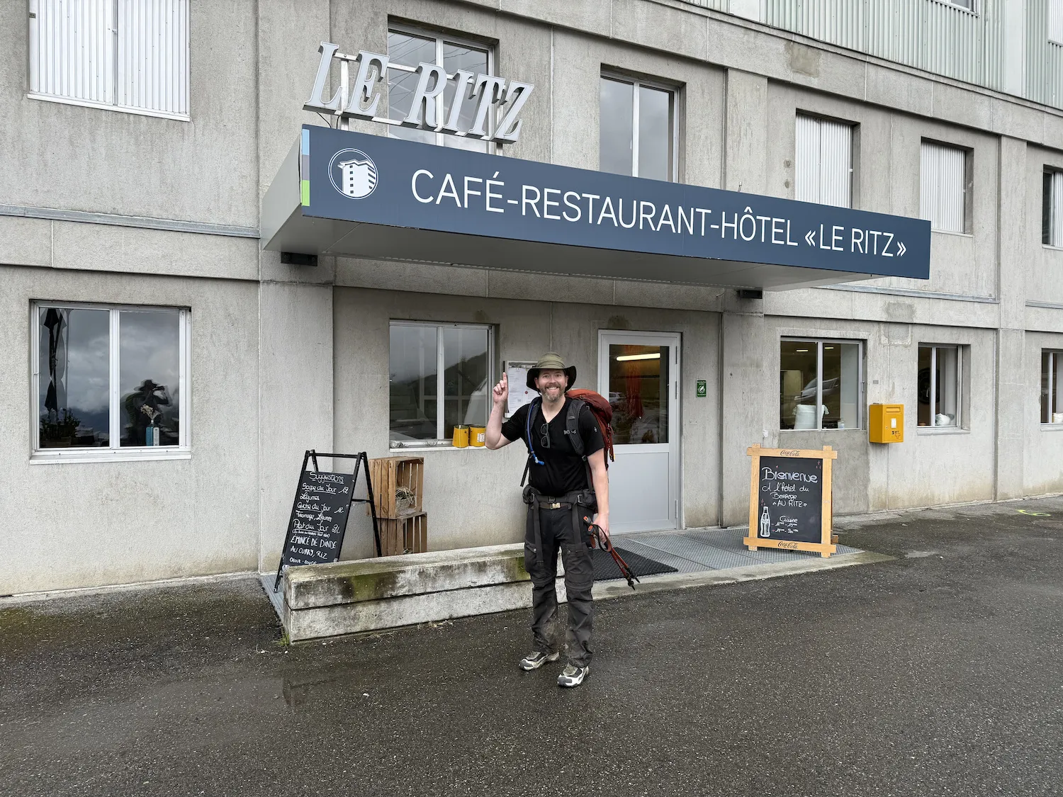 Man in front of hotel sign