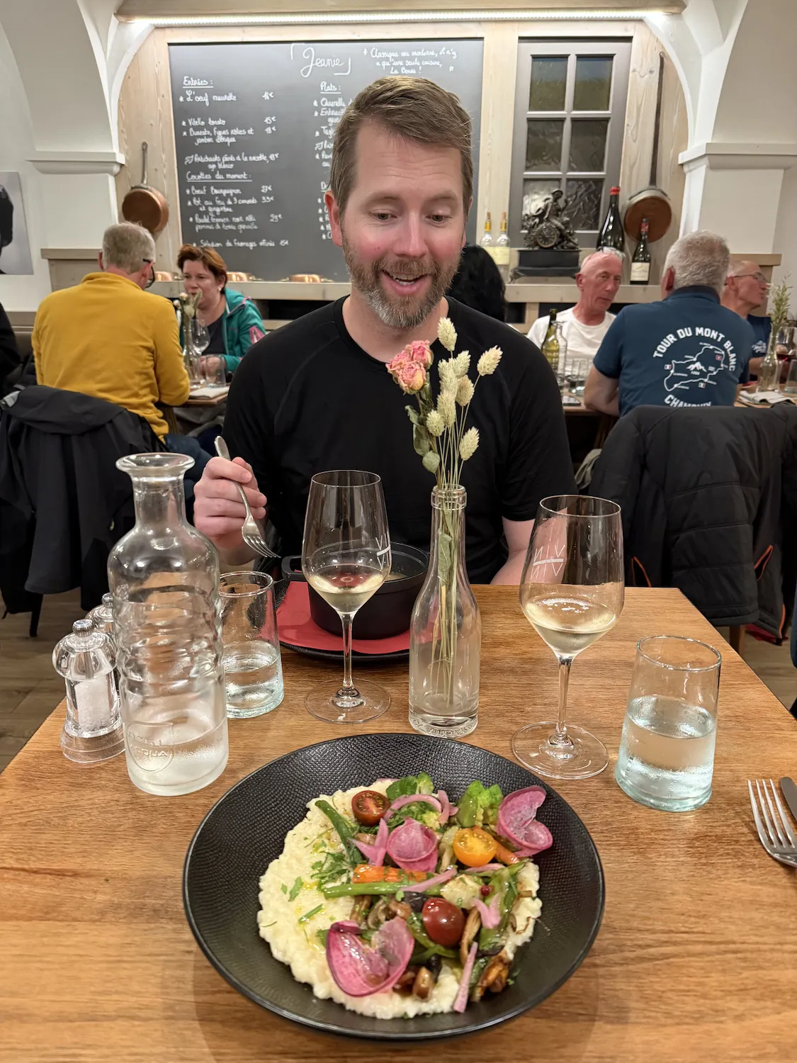 Grant in front of dinner table with risotto