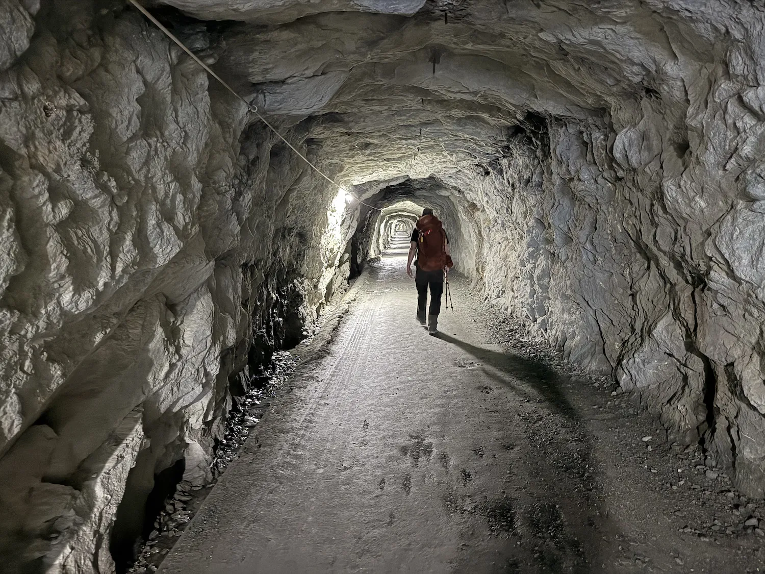 Man walking through tunnel