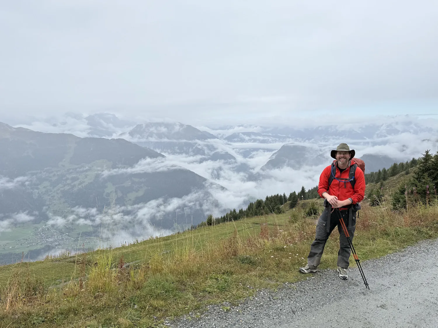 Man in front clouds and city below