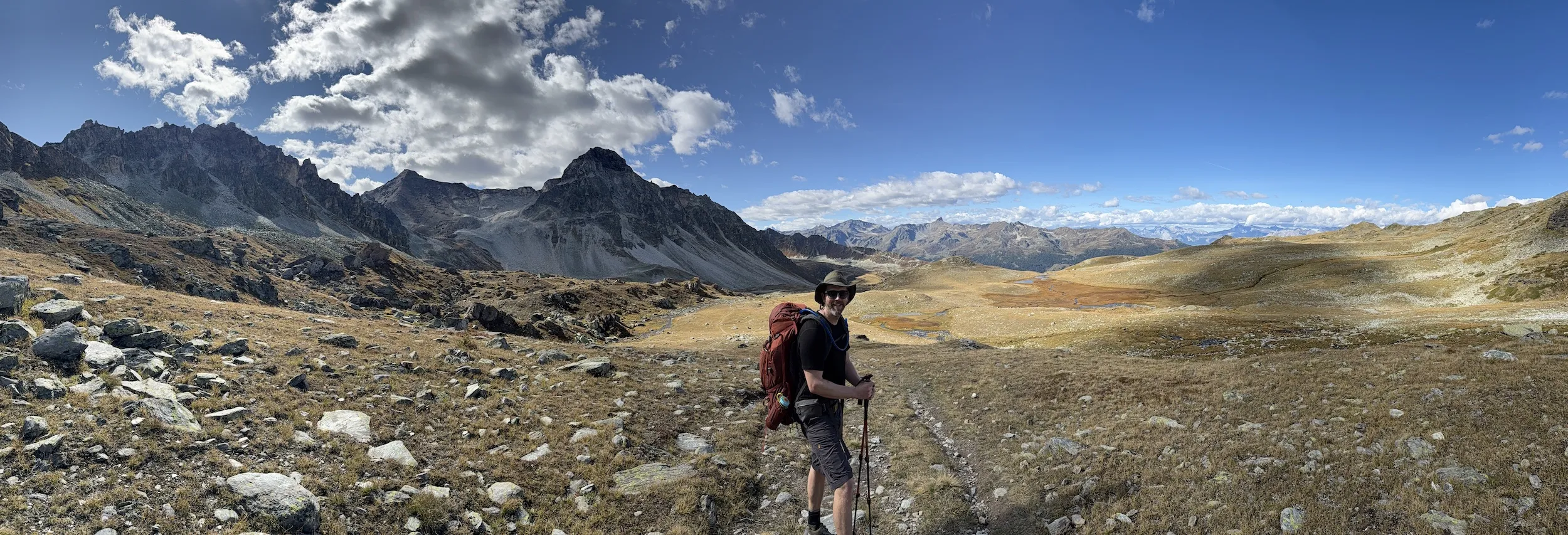 Panoramic view of man standing with mountains in the distance