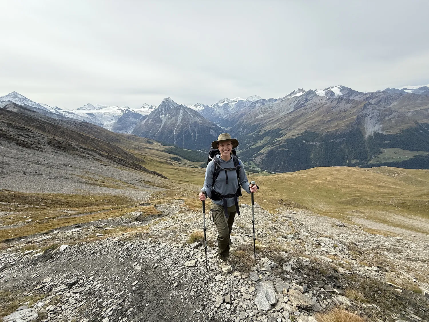 Woman on rocky terrain in front of mountains