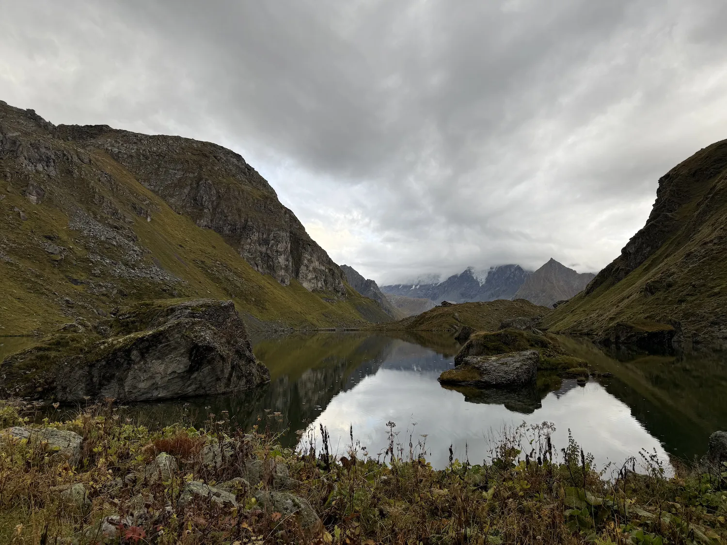 Alpine lake with cloudy mountains in the back