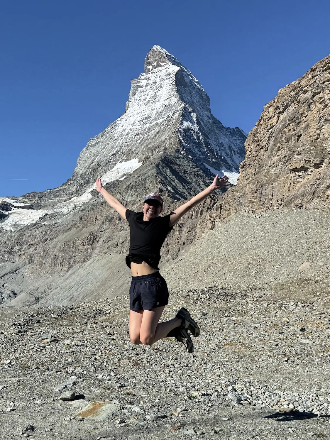 Woman jumping in front of the Matterhorn