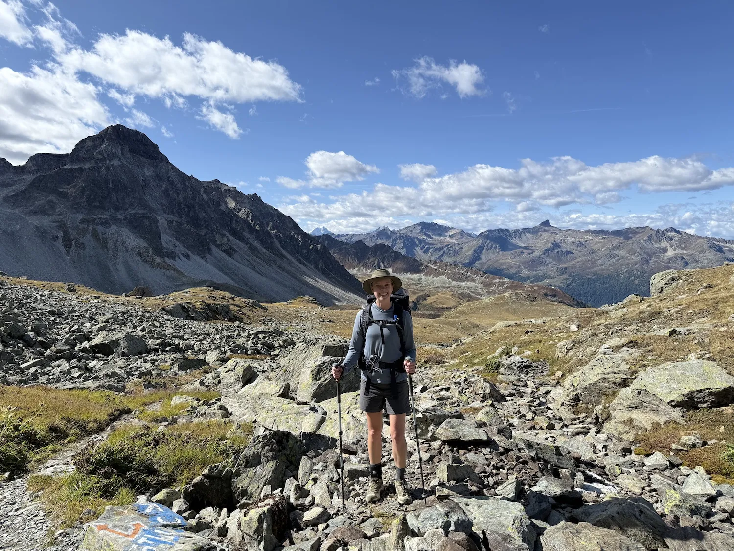 Woman in boulders in front of mountains