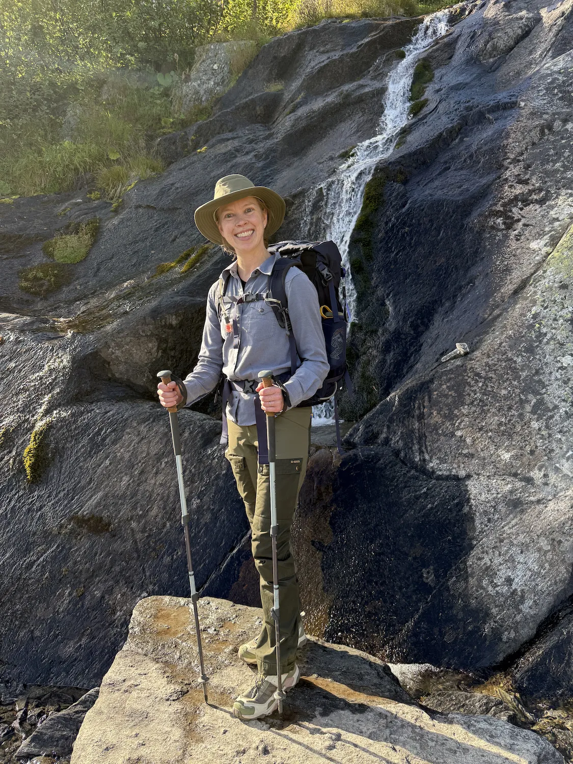 Sheryl standing in front of waterfall