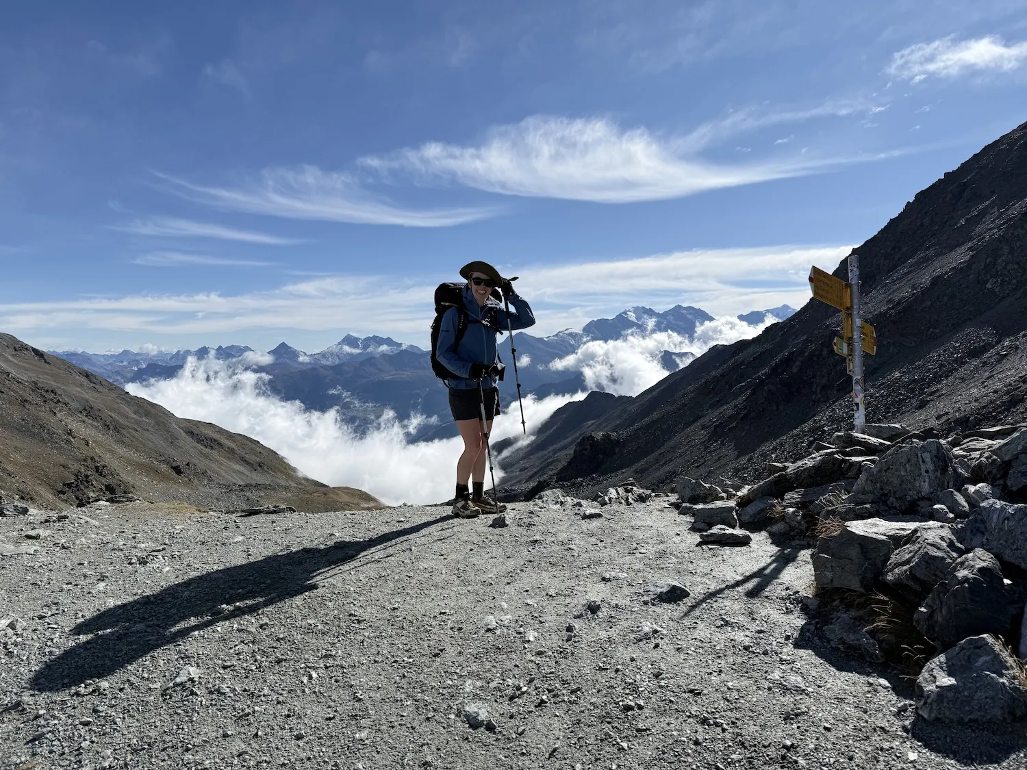 Woman holding hat on windy peak