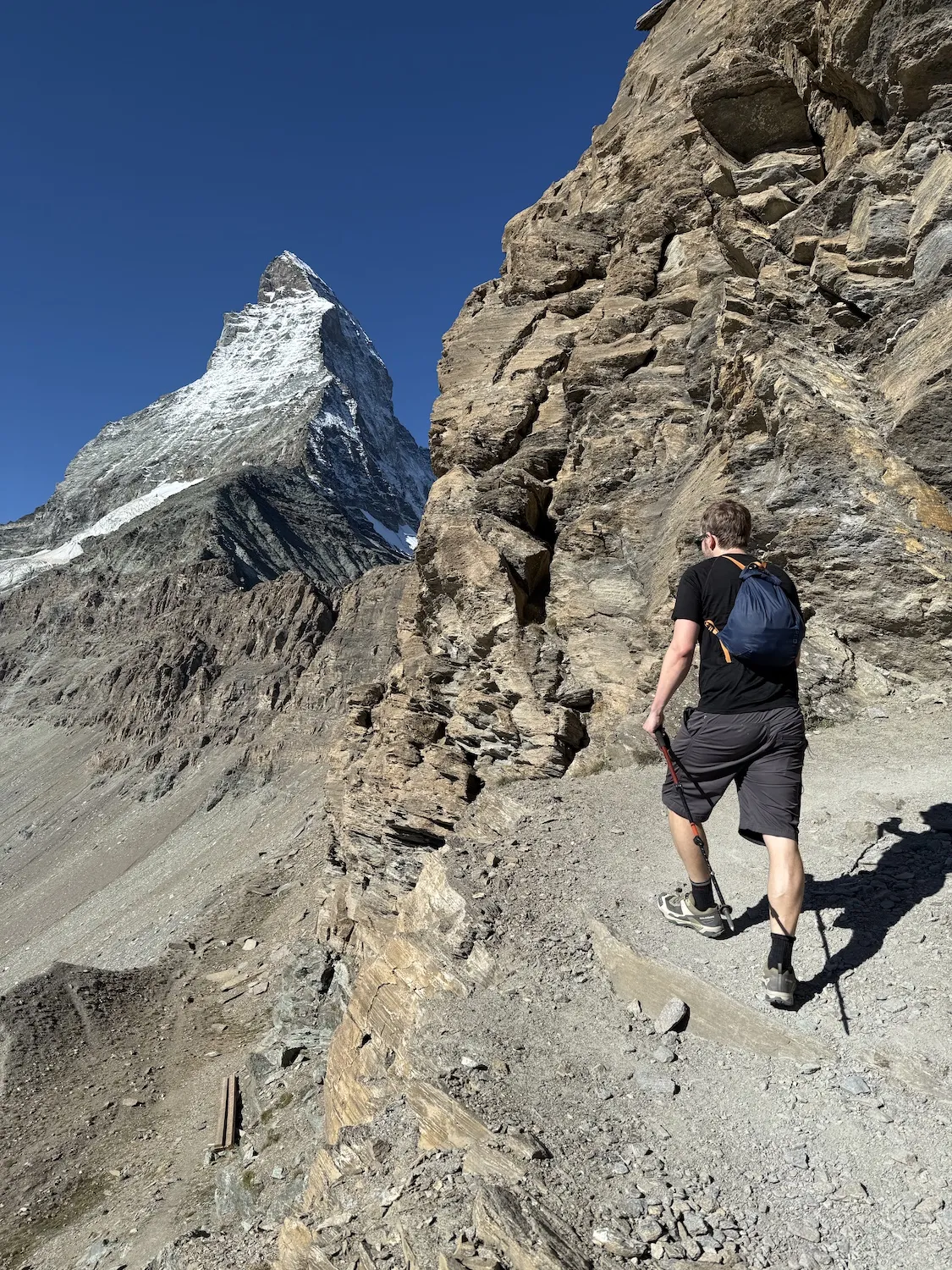 Man hiking in front of the Matterhorn