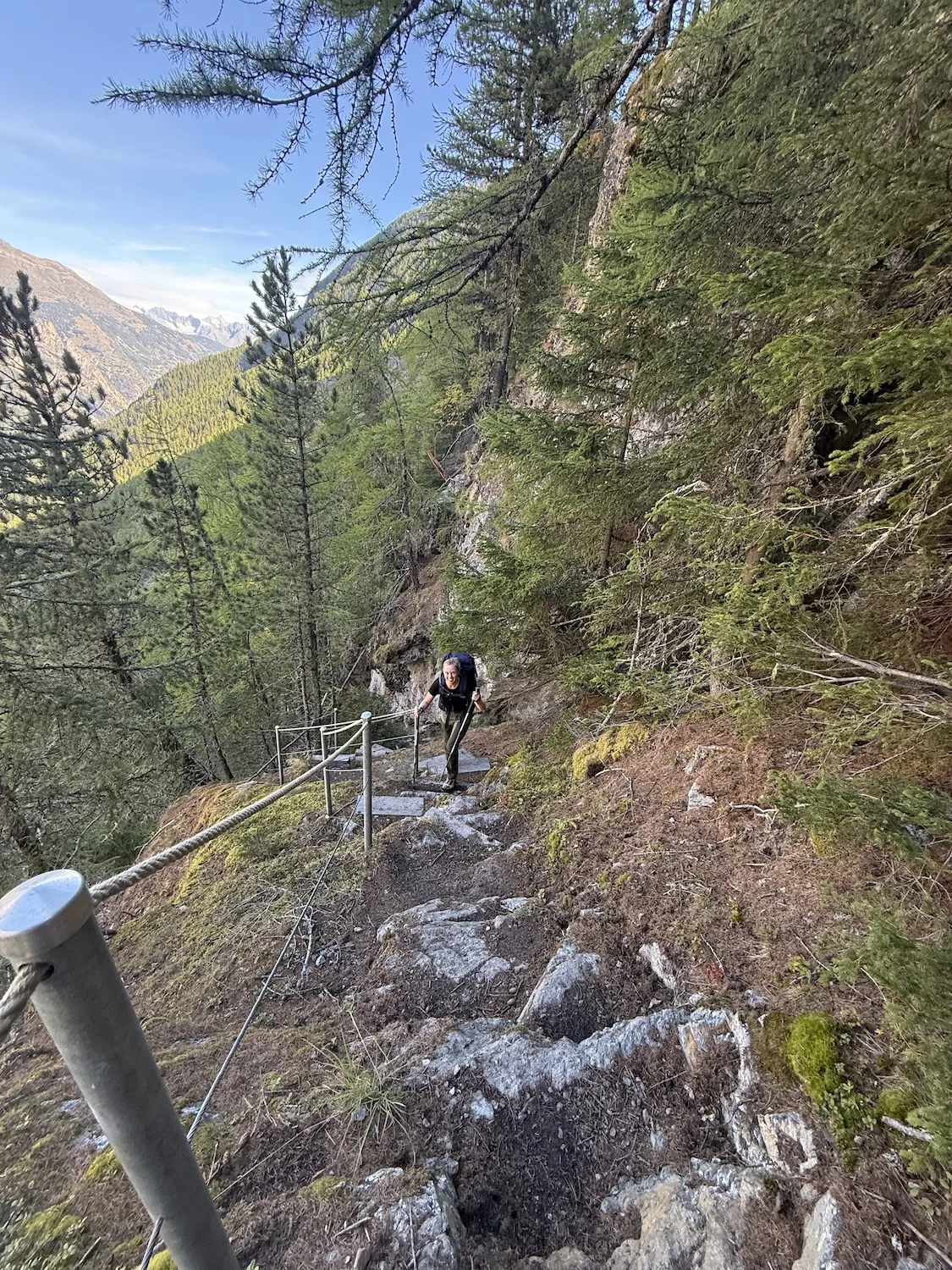 Woman climbing steep staircase in mountains