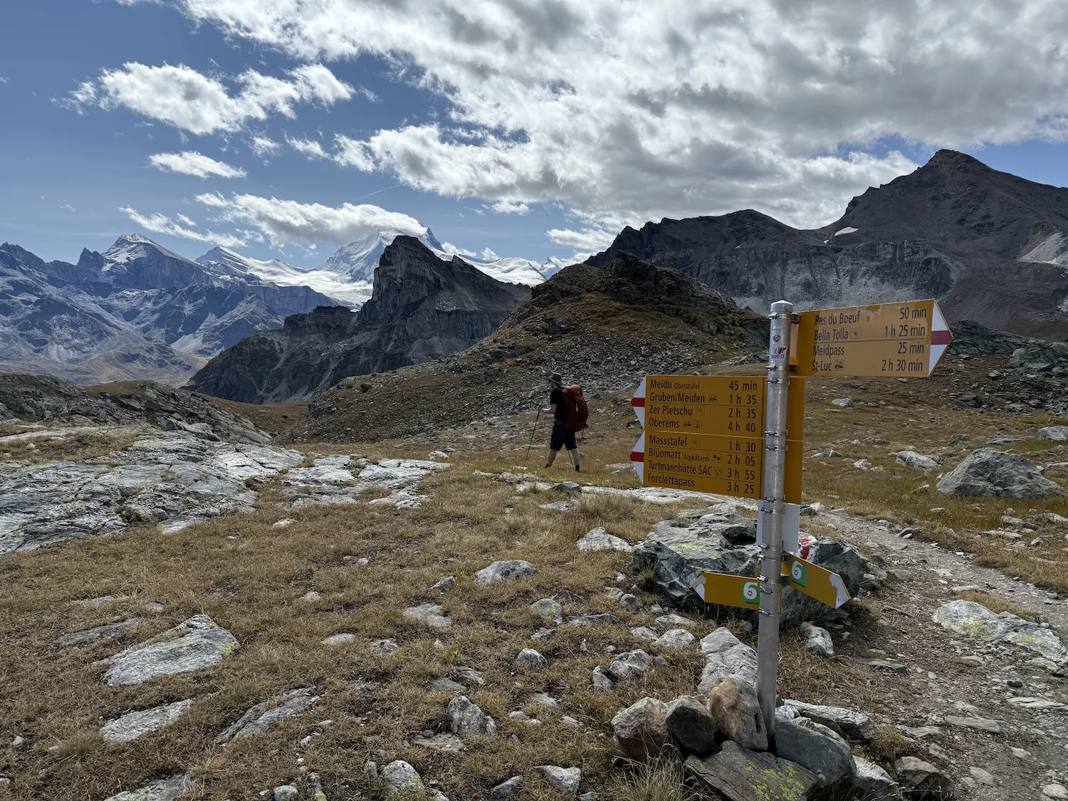 Sign with man walking in the background